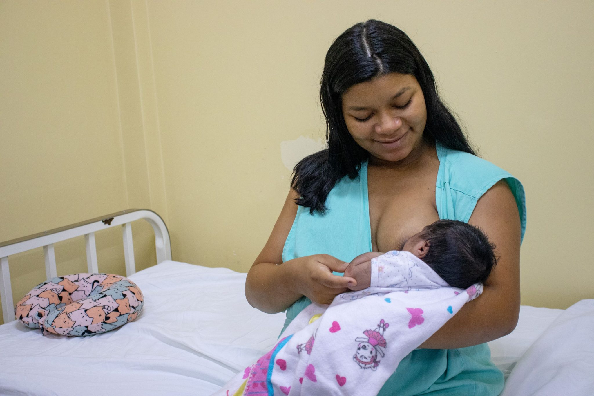 Mãe amamentando bebê em unidade de saúde de Manaus